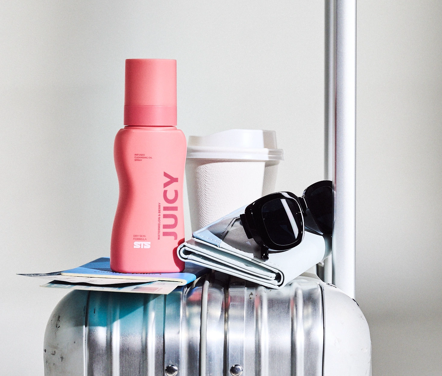 Juicy cleansing oil on a silver suitcase